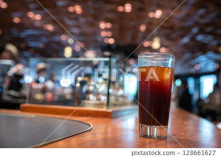 Ice Americano in grass by coffee machine on table, Shanghai, China 128661627