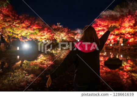 tourist woman raise hands and view autumn colors, Toji temple, Kyoto 128661639