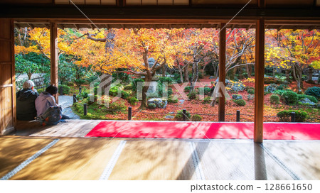 Japanese old couple in Enkoji temple hall view fall garden, Kyoto Japanese old couple in Enkoji temple hall view fall garden, Kyoto 128661650