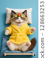 Funny cat in a robe with a cucumber mask 128663253