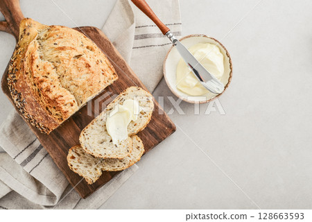 Tasty multigrain french bread with butter Tasty multigrain french bread with butter 128663593