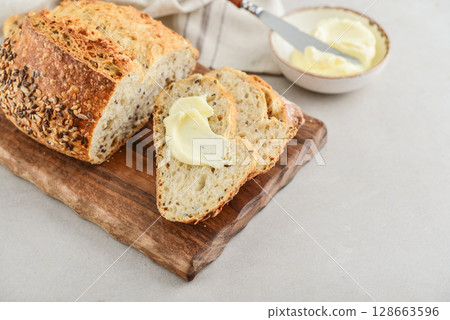 Tasty multigrain french bread with butter Tasty multigrain french bread with butter 128663596