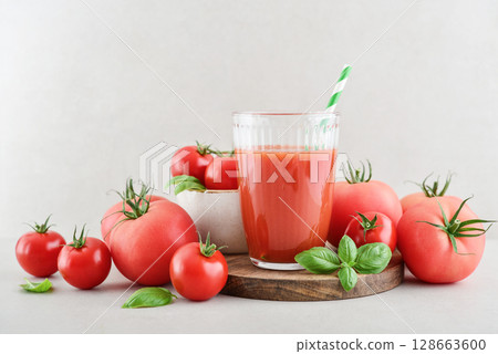 Tomato juice in a glass and fresh tomatoes 128663600