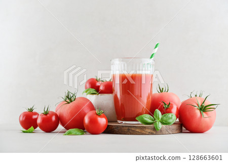 Tomato juice in a glass and fresh tomatoes Tomato juice in a glass and fresh tomatoes 128663601