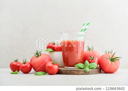 Tomato juice in a glass and fresh tomatoes Tomato juice in a glass and fresh tomatoes 128663602