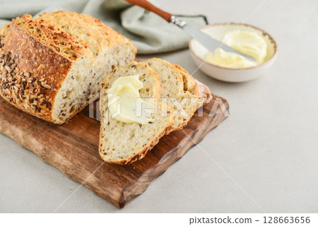 Tasty multigrain french bread with butter 128663656