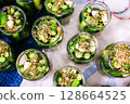 Homemade Pickled Cucumbers in Glass Jars with Spices and Herbs 128664525
