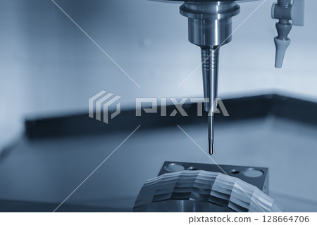 The CNC milling machine finish cut the mold parts by solid ball nose end mill tool in the light blue scene. 128664706
