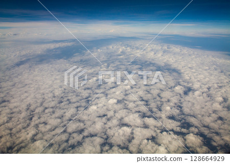 beautiful thick clouds in the sky from the height of the plane 128664929