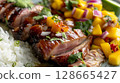 Close-up of Peking Duck with Mango Salsa, highlighting tender duck slices, vibrant salsa, and jasmine rice 128665427