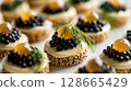 Close-up of Caviar with Quail Eggs, showcasing halved quail eggs topped with luxurious caviar and garnished with dill 128665429