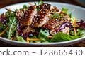 Peking Duck Salad: crispy skin on greens with hoisin vinaigrette, sesame seeds, and wonton strips 128665430