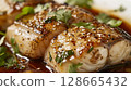 Ginger-Soy Turbot Meuniere: Tender turbot with ginger-soy marinade, served with ginger-soy sauce and fresh cilantro 128665432