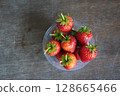 top view many fresh strawberries in a clear plastic glass lid on a wooden table background, fruit, food, decor, object, copy space 128665466