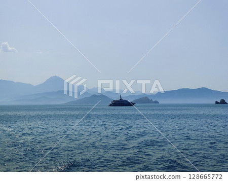 a beautiful ship is sailing in the blue sea 128665772