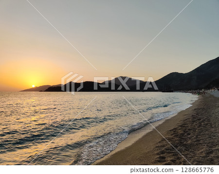 beautiful dramatic landscape of sunset on the sea beach beautiful dramatic landscape of sunset on the sea beach 128665776