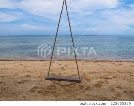 swing on a sandy beach on the sea 128665839