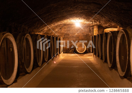 many barrels of wine in the cellar at the winery many barrels of wine in the cellar at the winery 128665888