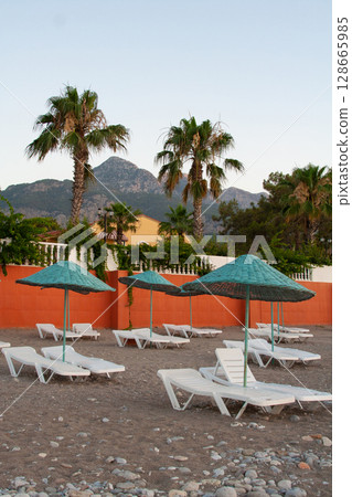 deck chairs and umbrellas on the sea beach in summer deck chairs and umbrellas on the sea beach in summer 128665985