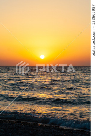 beautiful dramatic landscape of sunset on the sea beach 128665987
