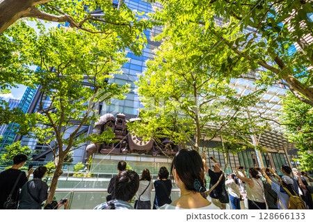 Tokyo cityscape in Japan: A view of the symbol of Shiodome, bustling with foreign tourists, including the mechanical clock "NTV Big Clock" 128666133
