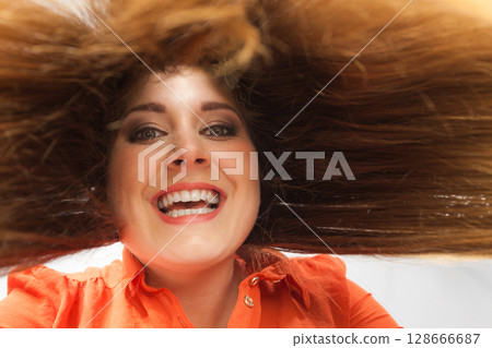 Happy positive woman with long brown hair Happy positive woman with long brown hair 128666687