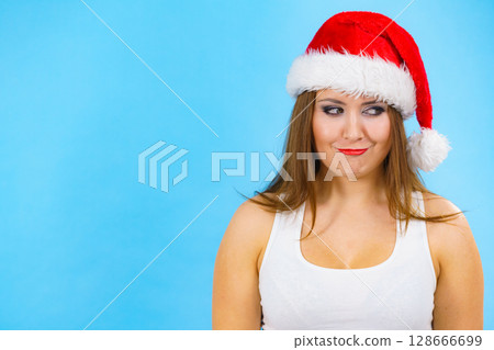 Woman in christmas santa hat on blue 128666699