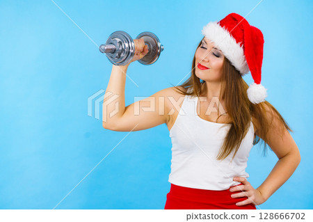 Santa claus woman lifting dumbbells 128666702