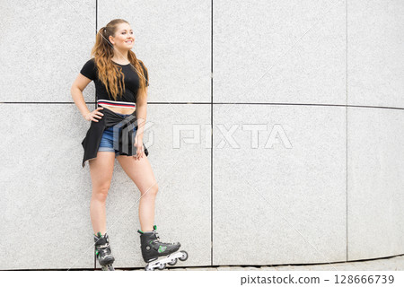 Young woman riding roller skates Young woman riding roller skates 128666739