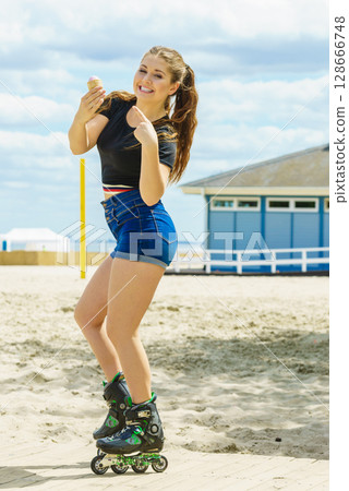Roller skate woman eating ice cream 128666748