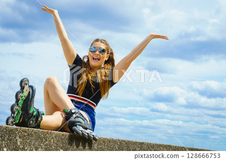 Fit girl with roller skates outdoor Fit girl with roller skates outdoor 128666753