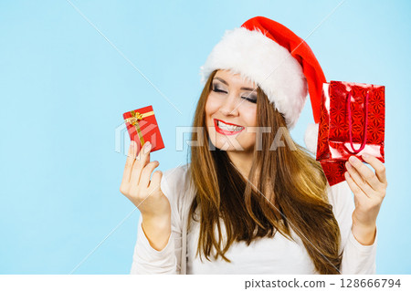 Happy Christmas woman holds red gift box Happy Christmas woman holds red gift box 128666794