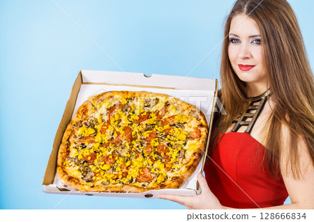 Woman holding big pizza in box 128666834