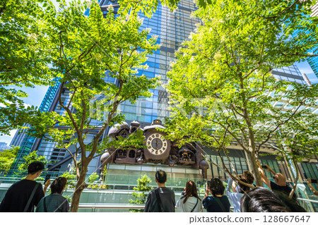 Tokyo cityscape in Japan: A view of the symbol of Shiodome, bustling with foreign tourists, including the mechanical clock "NTV Big Clock" 128667647