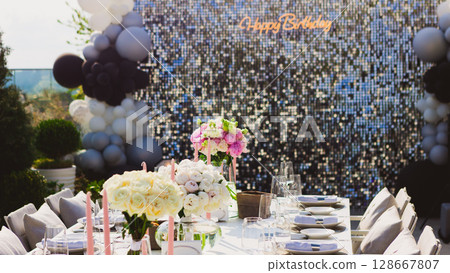 Featuring a dazzling sequin backdrop with a Happy Birthday neon sign, elegant table settings, Featuring a dazzling sequin backdrop with a Happy Birthday neon sign, elegant table settings, 128667807