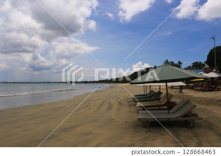 deck chairs and umbrellas on the sea beach in summer deck chairs and umbrellas on the sea beach in summer 128668463