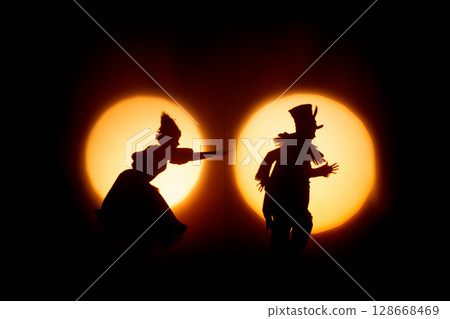 human silhouettes against the light in the theater during the performance human silhouettes against the light in the theater during the performance 128668469
