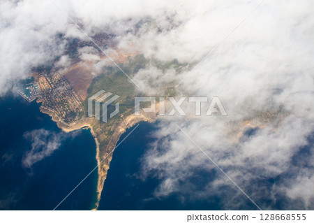 beautiful thick clouds in the sky from the height of the flight of the plane with a view of the continent and countries beautiful thick clouds in the sky from the height of the flight of the plane with a view of the continent and countries 128668555