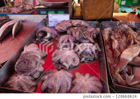 fresh marine species of cuttlefish and octopus on the counter 128668624