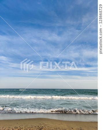 beautiful landscape on the coast of the beach and sea waves against the background of the blue sky beautiful landscape on the coast of the beach and sea waves against the background of the blue sky 128668729