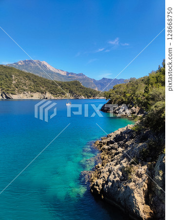 a beautiful ship is sailing in the blue sea a beautiful ship is sailing in the blue sea 128668750