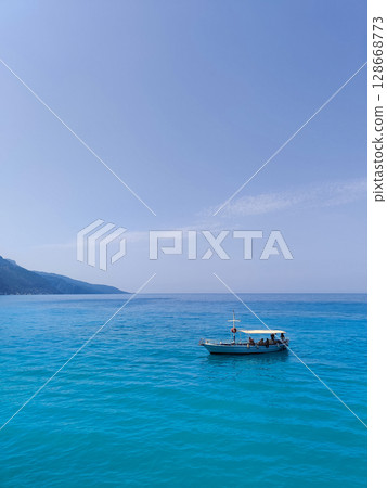 a beautiful ship is sailing in the blue sea 128668773