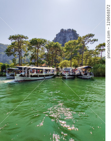 beautiful ships and boats are moored near the shore beautiful ships and boats are moored near the shore 128668872