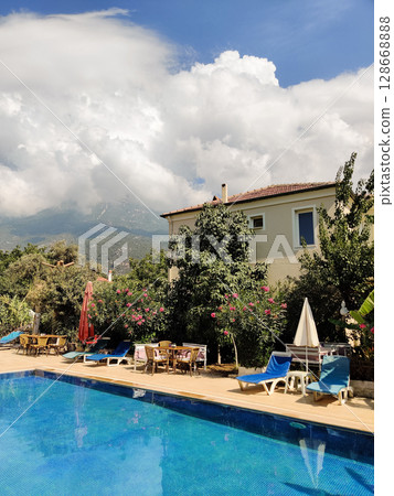 a beautiful large swimming pool near the house 128668888