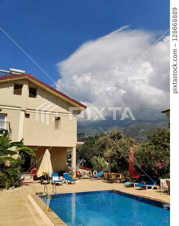 a beautiful large swimming pool near the house 128668889