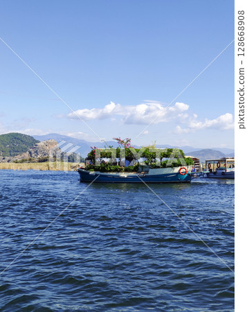 beautiful ships and boats are moored near the shore 128668908