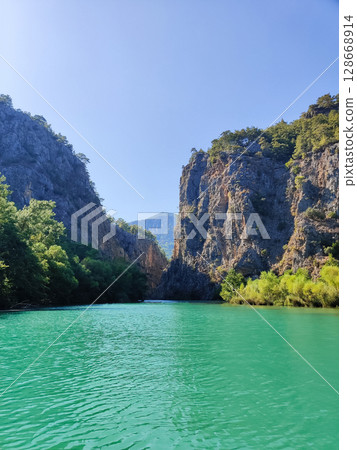 high rocky mountains on the banks of the river 128668914