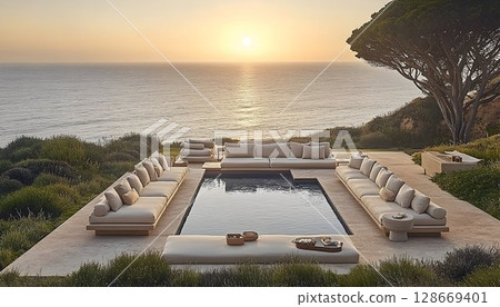 Luxury outdoor furniture by ocean sunset poolside 128669401