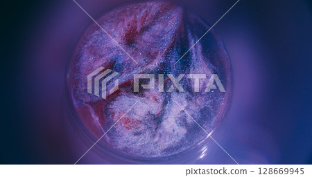 Spatter drop. Sparkling splash. Defocused purple red neon ink color rainbow round shiny texture spreading on abstract light creative background. Spatter drop. Sparkling splash. Defocused purple red neon ink color rainbow round shiny texture spreading on abstract light creative background. 128669945