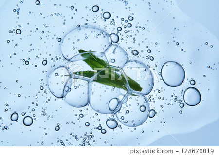 A drop of shampoo with bubbles. A texture with a leaf in it. 128670019